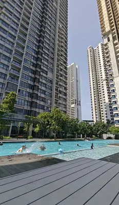people in a swimming pool in a city with tall buildings at ASTORIA AMPANG, 6Pax - Near KLCC, ZooNegara, AmpangPoint Mall in Kuala Lumpur