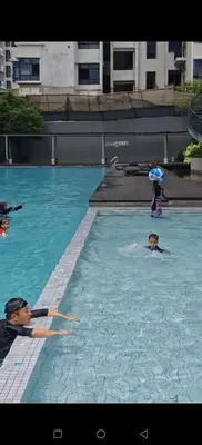a group of people swimming in a swimming pool at ASTORIA AMPANG, 6Pax - Near KLCC, ZooNegara, AmpangPoint Mall in Kuala Lumpur