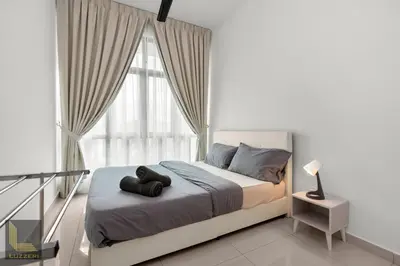 a bedroom with a bed with two black objects on it at Legasi Kampung Baru Guesthouse in Kuala Lumpur