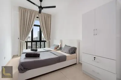 a bedroom with a large bed with a window at Legasi Kampung Baru Guesthouse in Kuala Lumpur
