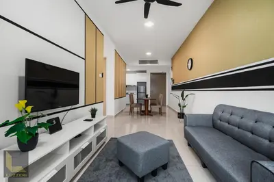 a living room with a couch and a tv at Legasi Kampung Baru Guesthouse in Kuala Lumpur