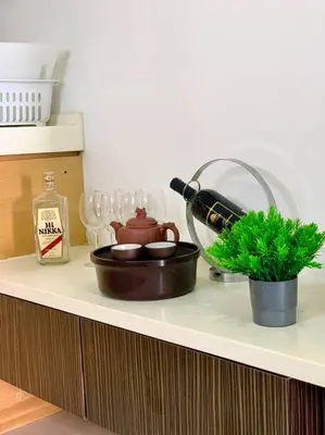 a counter top with a bottle of wine and a plant at Private Jacuzzi Staycation at KL City 152 in Kuala Lumpur
