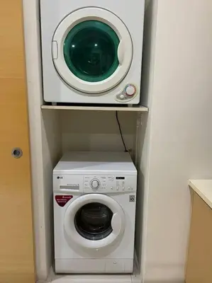 a washer and a washing machine in a room at Private Jacuzzi Staycation at KL City 921 in Kuala Lumpur