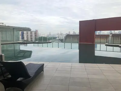 a balcony of a building with a view of a pool at Private Jacuzzi Staycation at KL City 921 in Kuala Lumpur