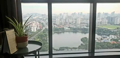 a window with a plant on a table and a view of a city at MCity Jalan Ampang KLCC in Kuala Lumpur