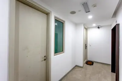 a hallway with a white wall and a door at Rex Ollie @ Myhabitat Condominium in Kuala Lumpur