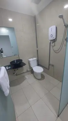 a bathroom with a toilet and a sink at ONE AMPANG HOTEL in Ampang