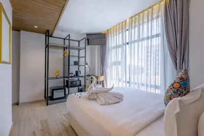a bedroom with a large bed with a large window at Santa Grand Classic Kuala Lumpur, Chinatown in Kuala Lumpur