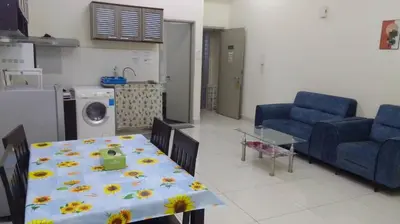 a living room with a table and two blue chairs at Vue Residence Servis Suite 3 pax Studio in Kuala Lumpur