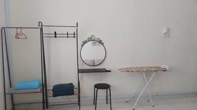 a dressing room with a mirror and a stool at Vue Residence Servis Suite 3 pax Studio in Kuala Lumpur
