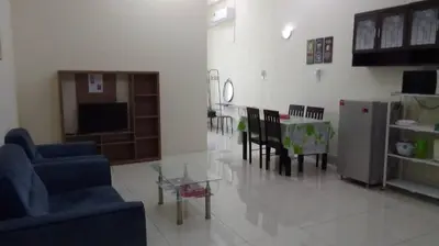 a living room with a couch and a table and chairs at Vue Residence Servis Suite 3 pax Studio in Kuala Lumpur