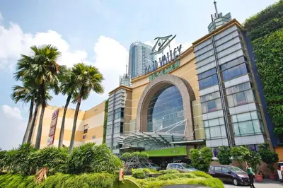 a large building with palm trees in front of it at KL Sentral Loft, EST Bangsar #3, LRT in Kuala Lumpur
