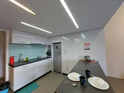 a kitchen with white cabinets and a counter top at KL Sentral Loft, EST Bangsar #3, LRT in Kuala Lumpur