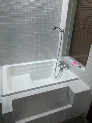 a white bath tub with a shower in a bathroom at Bangsar Studio suites in Kuala Lumpur
