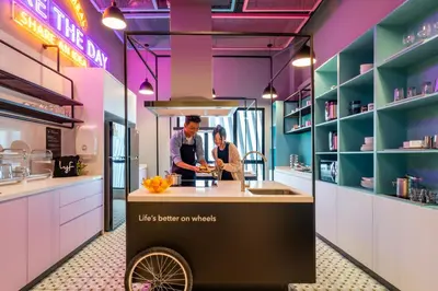 a man and woman preparing food in a kitchen at lyf Chinatown Kuala Lumpur in Kuala Lumpur