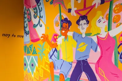 a book cover of a group of people painted on a wall at lyf Chinatown Kuala Lumpur in Kuala Lumpur