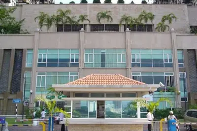 a large building with palm trees in front of it at 3min MITEC KL Publika Ocean Classic Condo 2308 in Kuala Lumpur