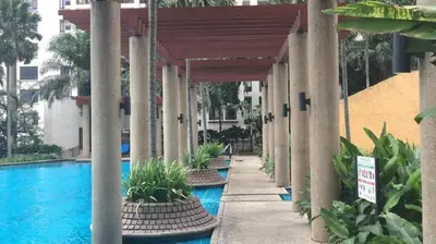 a pool at a hotel with pillars and a building at 3min MITEC KL Publika Ocean Classic Condo 2308 in Kuala Lumpur