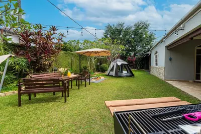 a backyard with a picnic table and a tent at 25P Enchanting Bungalow Retreat - Mystical Garden,Petaling Jaya by Verano in Petaling Jaya