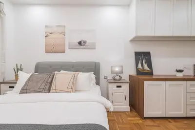 a white bedroom with a bed and a white cabinet at 25P Enchanting Bungalow Retreat - Mystical Garden,Petaling Jaya by Verano in Petaling Jaya