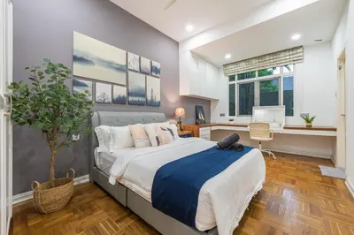 a bedroom with a large bed and a desk with a computer at 25P Enchanting Bungalow Retreat - Mystical Garden,Petaling Jaya by Verano in Petaling Jaya