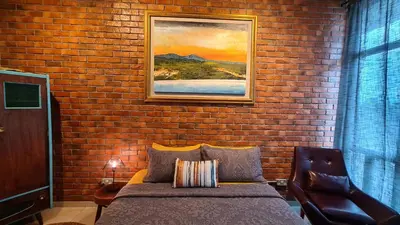 a bedroom with a brick wall with a bed at Rumah Kampong Bharu near KLCC (3Rooms) in Kuala Lumpur