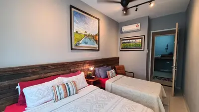 a hotel room with two beds and a mirror at Rumah Kampong Bharu near KLCC (3Rooms) in Kuala Lumpur