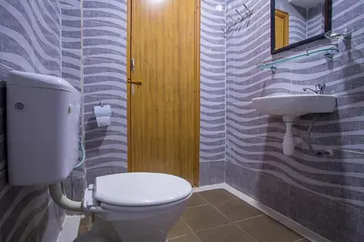 a bathroom with a toilet and a sink at MK Inn Hotel in Kuala Lumpur