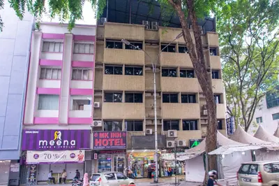 a tall building on a city street with cars at MK Inn Hotel in Kuala Lumpur
