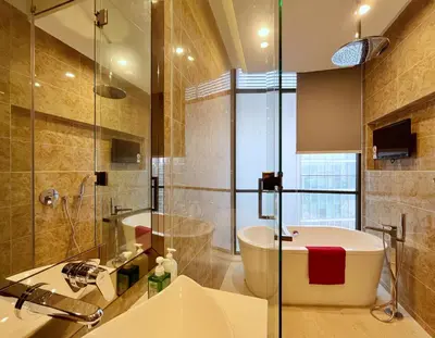 a bathroom with a tub and a sink and a shower at Nana's at Dorsett Residence Bukit Bintang in Kuala Lumpur
