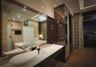 a bathroom with a white sink and a tub at Dorsett Residence Service Suite At Bukit Bintang KL in Kuala Lumpur