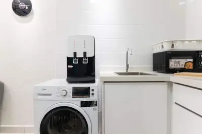 a kitchen with a washing machine and a sink at Arte Mont Kiara 3pax Jacuzzi Pool Gym near MITEC Matrade in Kuala Lumpur
