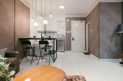 a kitchen and living room with a table and chairs at Arte Mont Kiara 3pax Jacuzzi Pool Gym near MITEC Matrade in Kuala Lumpur