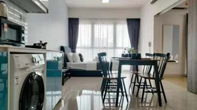 a kitchen and living room with a table and chairs at Continew Residence by HomeBrickz in Kuala Lumpur