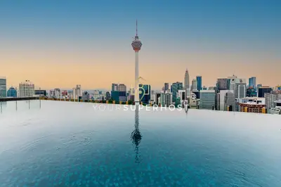 a view of the city from the rooftop pool of a skyscraper at Ceylonz Suites nr Pavilion & KLCC by YourSuperhost in Kuala Lumpur