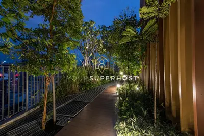 a walkway with trees on the side of a building at Ceylonz Suites nr Pavilion & KLCC by YourSuperhost in Kuala Lumpur