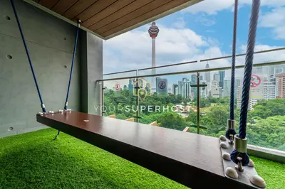 a swing in a building with a view of a city at Ceylonz Suites nr Pavilion & KLCC by YourSuperhost in Kuala Lumpur