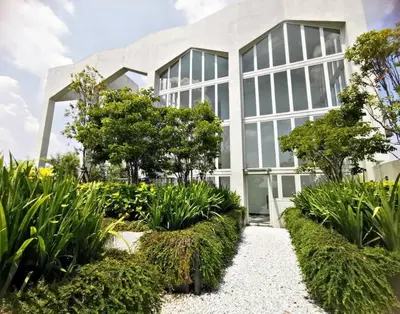 a building with a garden in front of it at ※THE UNIQUE HOME @ KL※ SUNWAY VELOCITY-TRX ◆2-7PAX in Kuala Lumpur