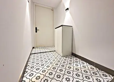 a hallway with a white door and a black and white tile floor at ※THE UNIQUE HOME @ KL※ SUNWAY VELOCITY-TRX ◆2-7PAX in Kuala Lumpur