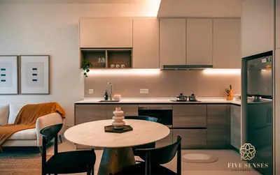 a kitchen with a table and chairs in a room at ViiA Residences Kuala Lumpur, Five Senses in Kuala Lumpur