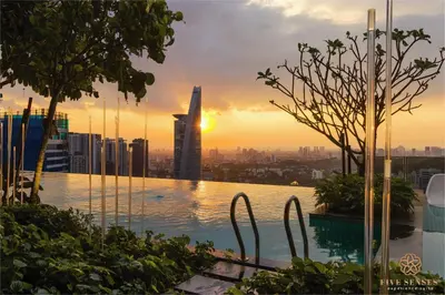 a pool with a view of a city at sunset at ViiA Residences Kuala Lumpur, Five Senses in Kuala Lumpur