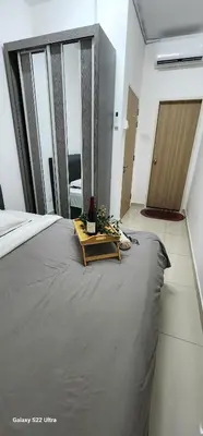 a bedroom with a large bed with a table on it at Legasi Kampung Baru apartment by rumahrehat in Kuala Lumpur