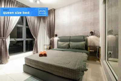 a bedroom with a green size bed with two shoes on it at Nj Homestay at Arte Mont Kiara in Kuala Lumpur