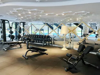 a gym with a lot of treadmills and weights at Nj Homestay at Arte Mont Kiara in Kuala Lumpur