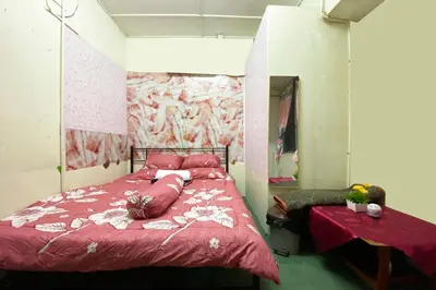 a bedroom with a red bed and a mirror at Hotel O Syariah Asam Pedas in Kuala Lumpur