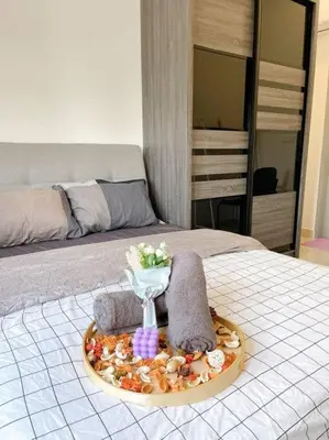 a tray of towels and towels on a bed at TR Residence Near Titiwangsa LRT By Iconique in Kuala Lumpur