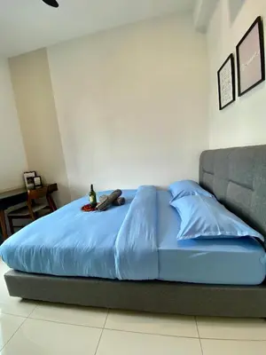 a bed with a blue comforter in a bedroom at TR Residence Near Titiwangsa LRT By Iconique in Kuala Lumpur
