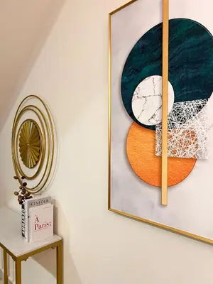 a picture hanging on a wall next to a table at Modern Suites at Arte Mont Kiara BY Iconique in Kuala Lumpur