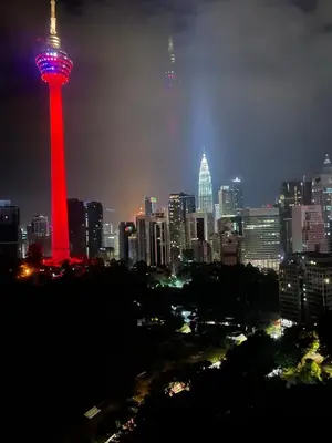 a lit up tower in a city at night at Ceylonz Suite Official in Kuala Lumpur