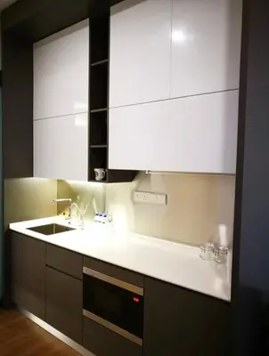 a kitchen with white cabinets and a sink at Ceylonz Suite Official in Kuala Lumpur